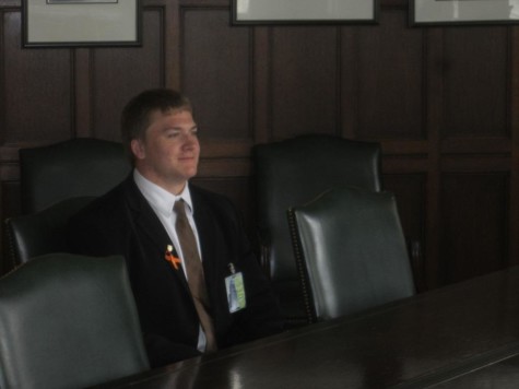Matt McKay takes a seat in the same chair that President Obama used in the Tribune board room.