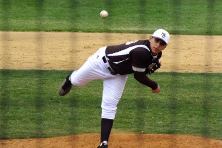 Senior Nelson Munoz firing a pitch from the mound towards the plate in a game this year.