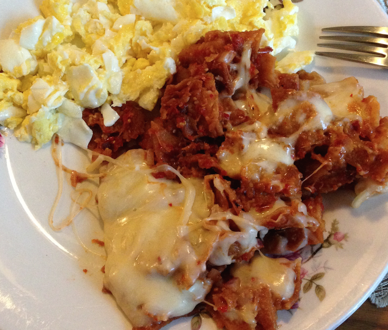 My+grandmas+homemade+chilaquiles+topped+with+chihuahua+cheese+and+a+side+of+scrambled+eggs.