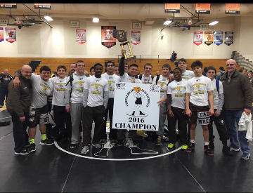 Coach Kading and the members of the Mount Carmel Wrestling team are all smiles after their victory at the Cheesehead Tournament.