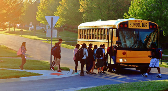 Kids getting on school bus. 