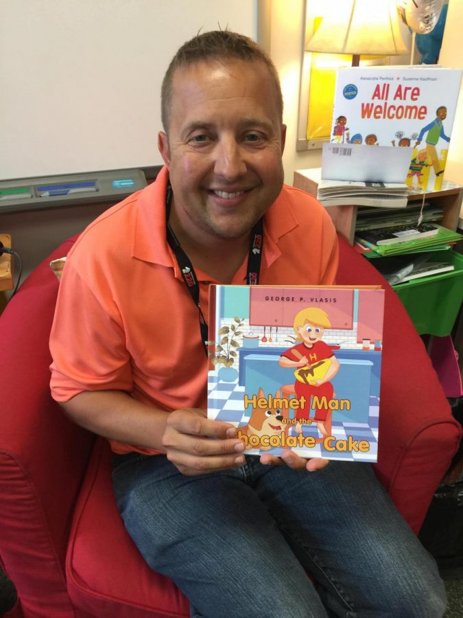 Mr. George Vlasis in the classroom with his newly published book Helmet Man and the Chocolate Cake