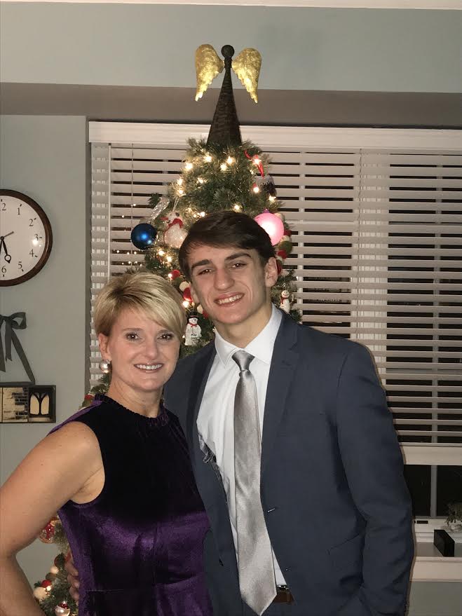 Senior Miles Hoey and his mother take pictures before the 2018 Mom Prom!