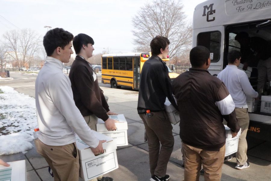 Students of Mr. McGuires studium load the MC bus for their trip to Maple-Morgan Park Food Pantry