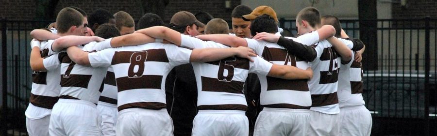 MC rugby gather around Coach Mike Holland as he gives a postgame talk.  (Photo credit:  Mount Carmel)