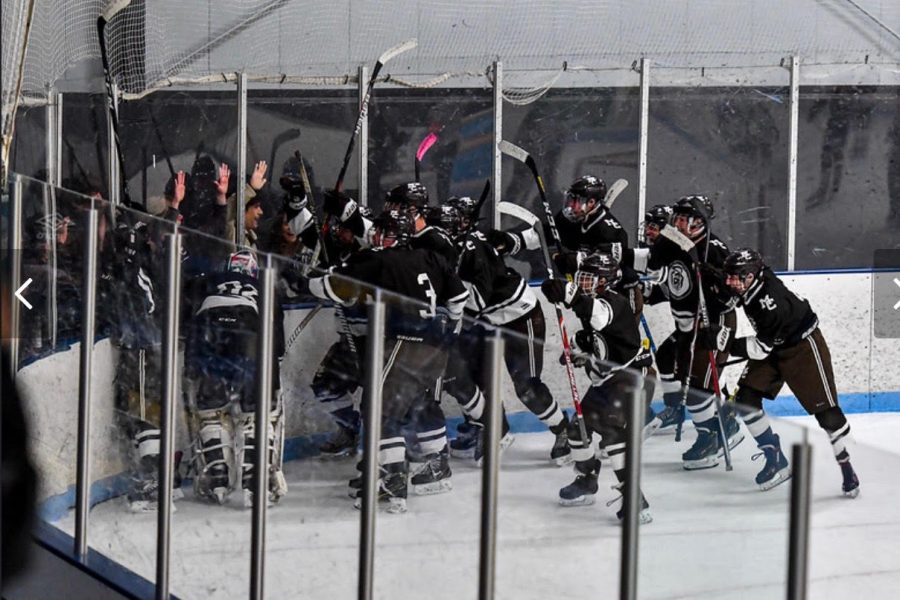 The Caravan hockey team celebrates with their fans with a victory