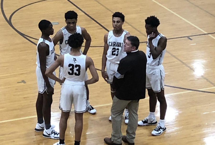 Coach Phil Segroves and the starting-five huddle up before a matchup against King on 1/18/20.