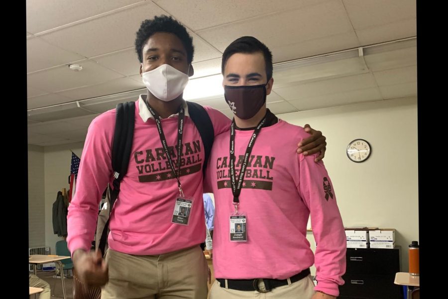 Seniors and teammates Blayr Young and Joe Goosherst show off their new volleyball tops, on sale last week in support of breast cancer research.