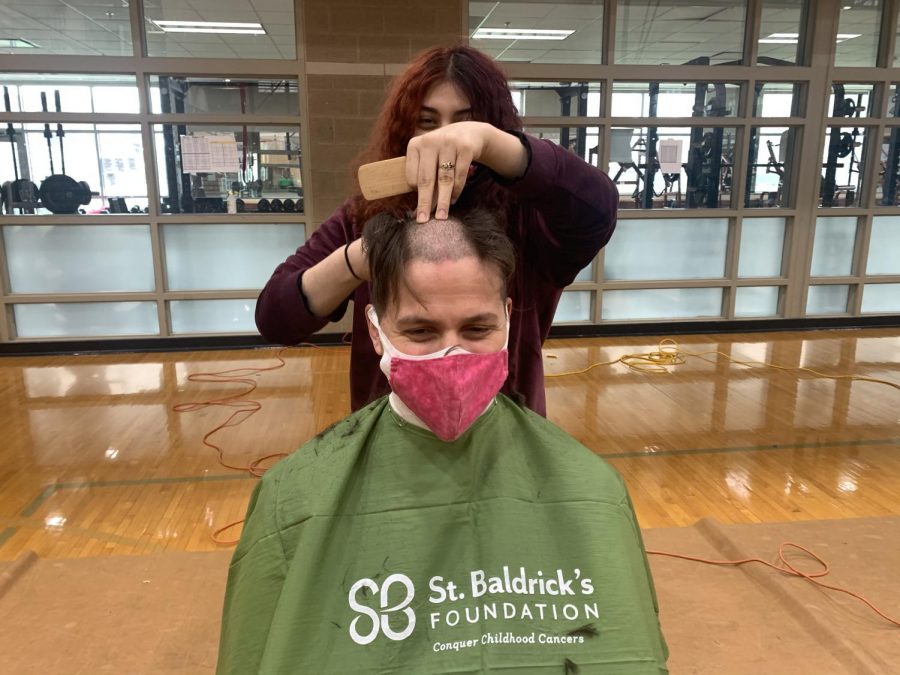 Mr. Brooks Nevrly getting his hair cut for his 3rd St. Baldricks Day 