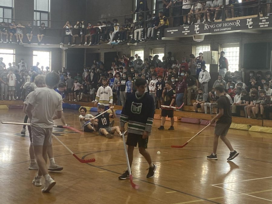 Students celebrate a goal in the Homecoming Week floor hockey game.