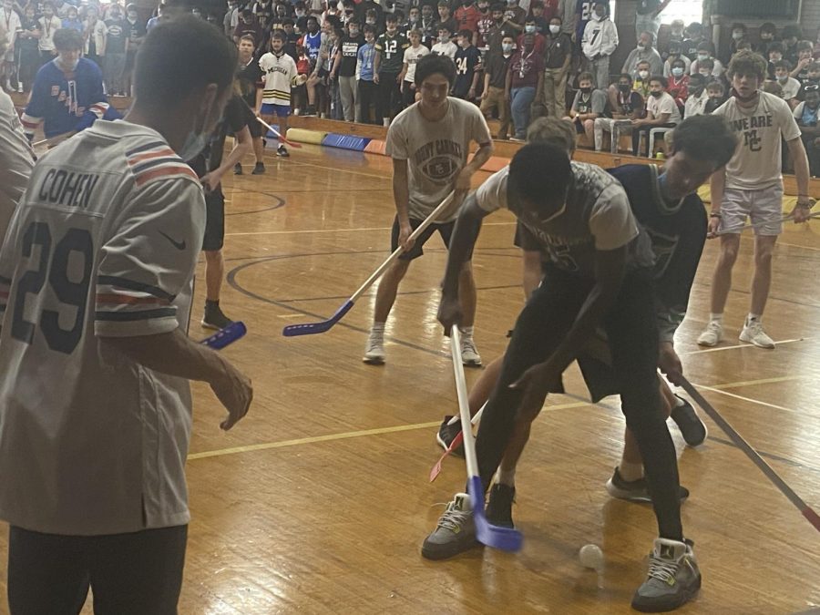 Students battle in the Homecoming Week floor hockey game.