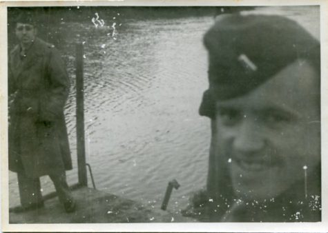 Photograph of U.S. army Lt. Robert J. Perry (left) while he stands near an unidentified soldier standing on a dock along a body of water in Europe during WWII (undated) [Photograph taken or collected by Pleasants  during his service in WWII]