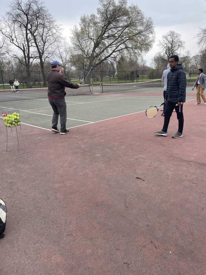 Coach Mark Antoinetti coaching the tennis team  on April 28, 2022