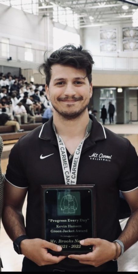 Mr.+Nevrly+holds+the+Kevin+Hansen+Green+Jacket+Award+plaque+after+winning+it+during+a+school+assembly+in+the+Cacciatore+Gym+on+Tuesday%2C+April+26.