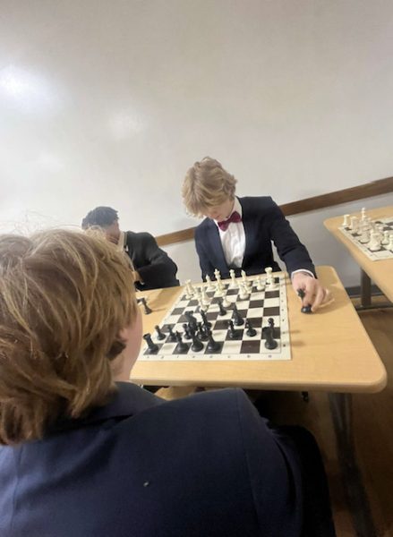 On Board Three, junior Declan Deering plays chess with fellow teammate junior Alex Urban.  