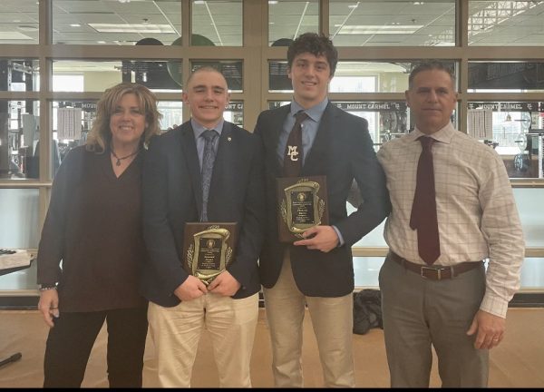 Dimas and Siegal proudly pose with their plaques that indicate they are tied for first in academics for the class of 2025. Standing with them are Mr. Andreas Dimas ’88 and Mrs. Kristen Dimas, who welcomed Siegal into their home last year.