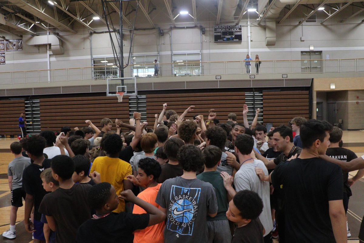 Mount Carmel players and campers break out from a huddle during last year’s basketball summer camp. 

