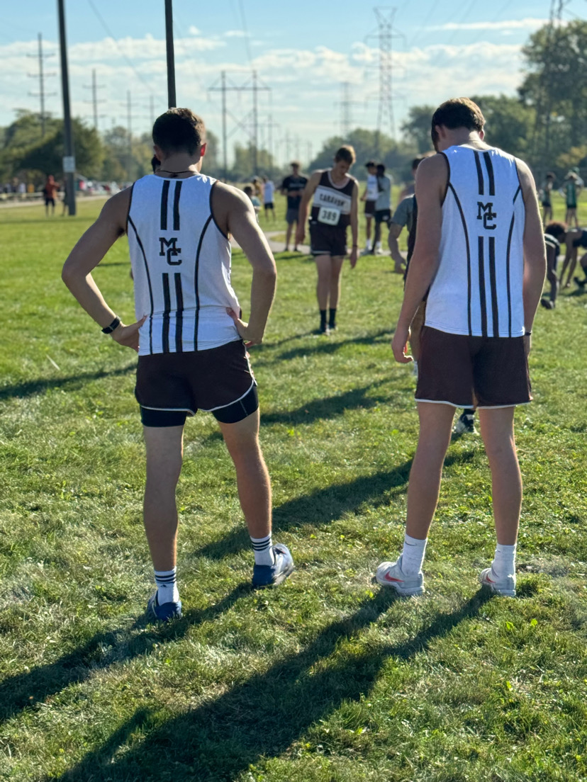 Christos Dimas (left) and Luke Segroves prepare for a cross country meet in Bedford Park.