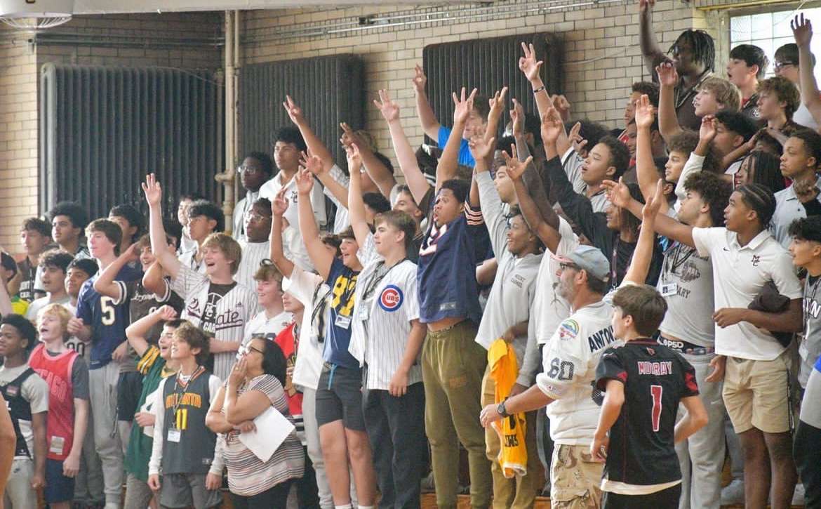 MC students cheer in the stands during the Spirit Week basketball game