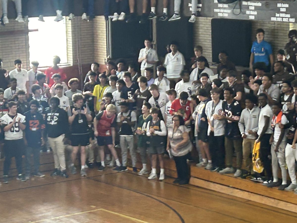 Sophomores in "Jersey Day" theme in the Alumni Gym cheer on their squad in the basketball game during 2024 Spirit Week.