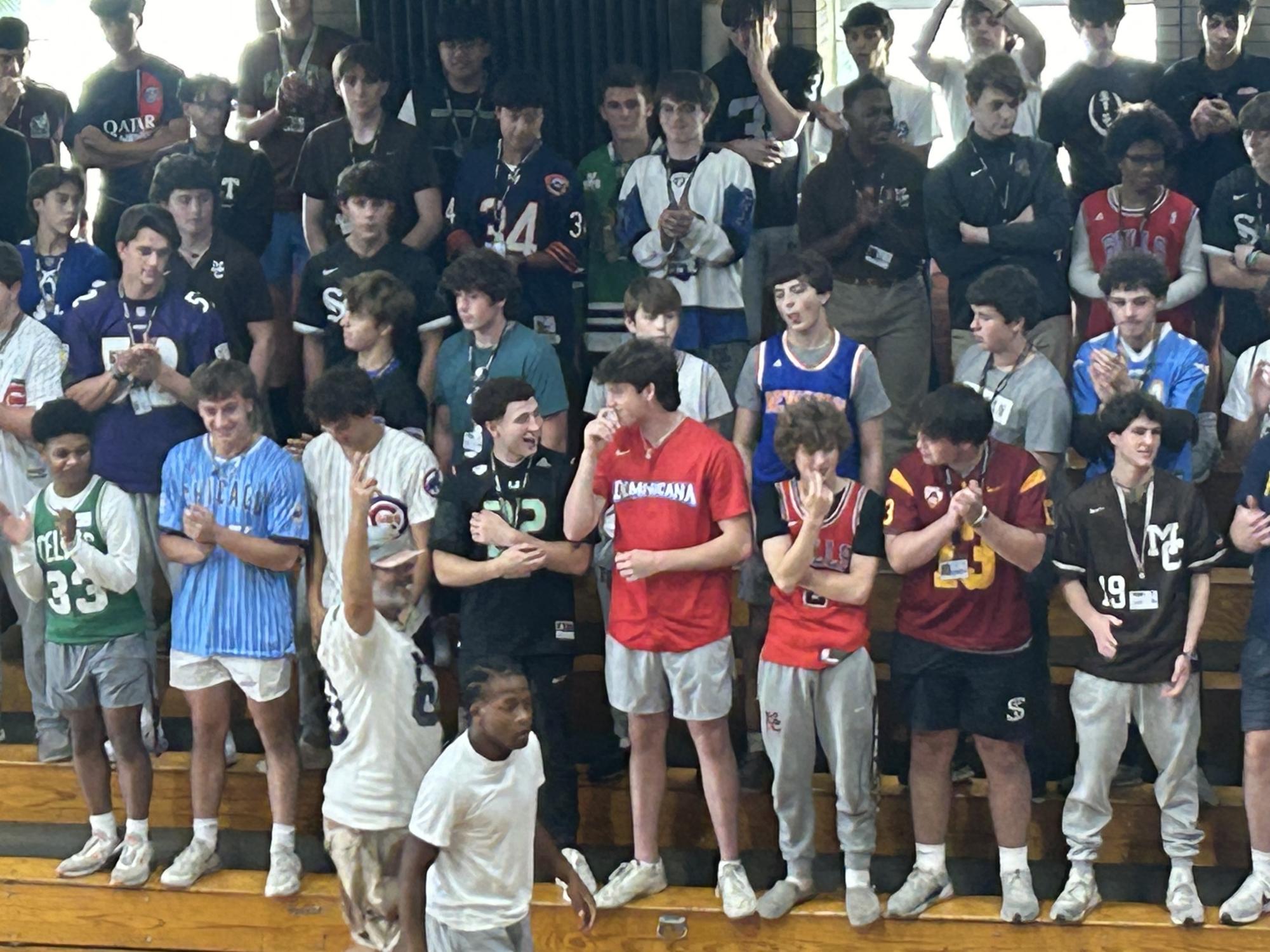 Juniors in "Jersey Day" theme in the Alumni Gym cheer on their squad in the basketball game during 2024 Spirit Week.