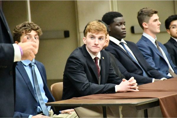 (sitting from left) Christos Dimas '25, Matt Malloy '25, Chukwebuka Odeluga '26, Kenneth Groen '26, and Angel Reyes '25 answer parent questions on during Honors Program Preview Night.