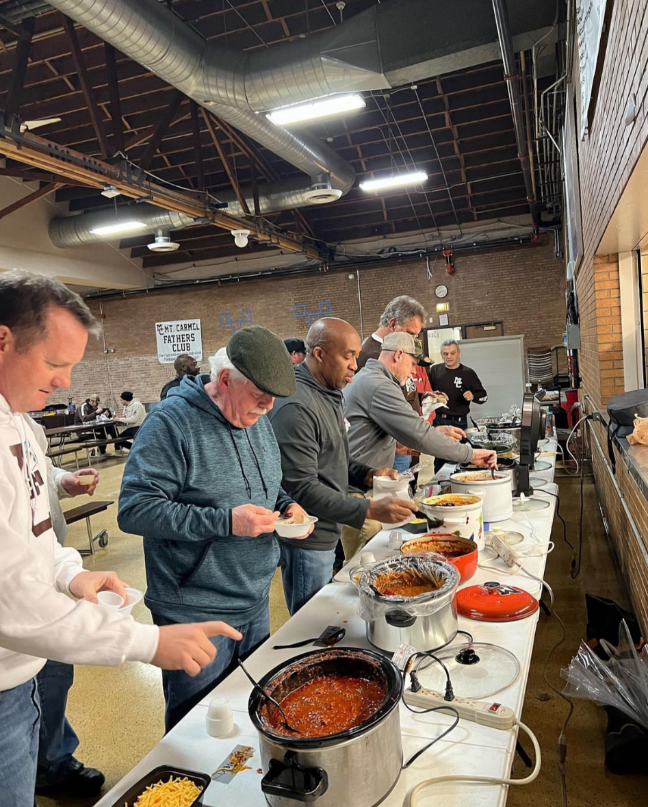 Mount Carmel Fathers’ Club members fill up at their annual chili cook off.   