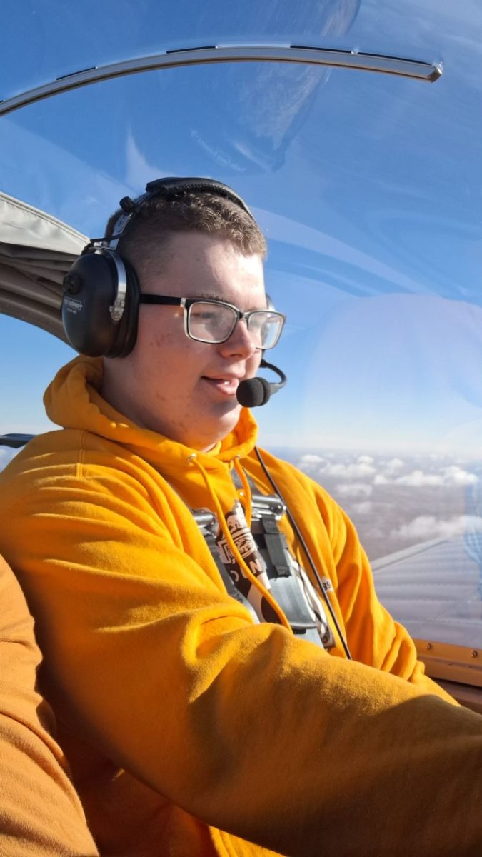 James McCormac '25 sits in a cockpit on his discovery flight that he took when exploring an interest in aviation.