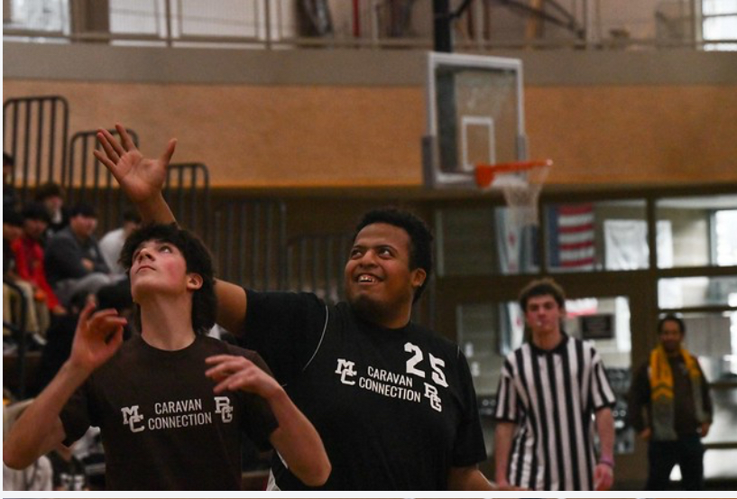 MC senior Jude Liss and a Ray Graham student go for a rebound in the basketball tournament on December 6, 2024.