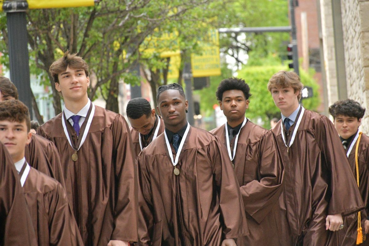 Seniors from the class of 2024 gather before entering their graduation ceremony at Holy Name Cathedral. 