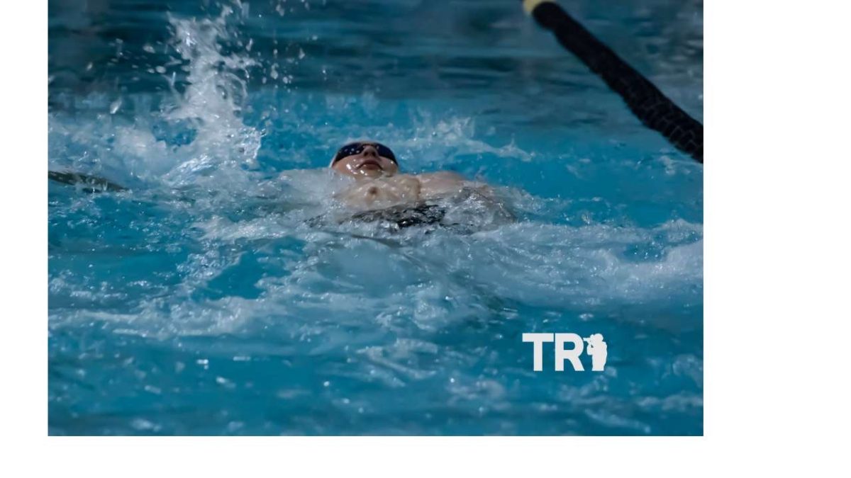 Senior Kaleb McCluer does a backstroke.