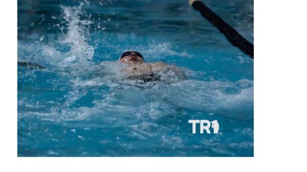 Senior Kaleb McCluer does a backstroke.