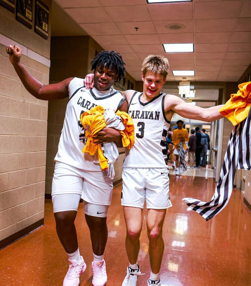 Mpouma (left) celebrates with senior Grant Best (right) after beating Brother Rice on the basketball court on February 14.