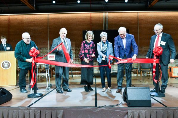 (From left to right) Fr. Jim Lewis, Mr. Don Barry ’63, Mrs. Peggy Barry, Mrs. Julie Hughes, Mr. Marty Hughes ’66, and President Brendan Conroy stand on the new stage in the Barry-Hughes Performing Arts Center to cut the ribbon.