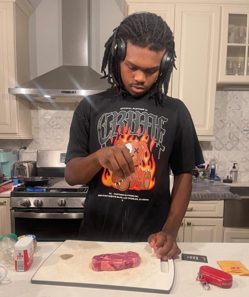 MC senior Ethan Edmond works on a meal in his kitchen at home.