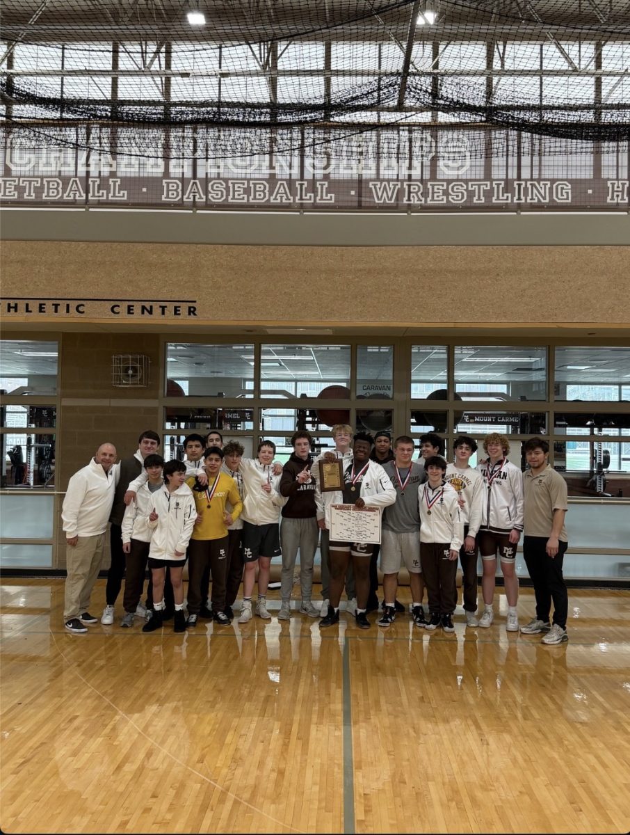 The Mount Carmel JV wrestling team shows off their CCL Tournament trophy.


