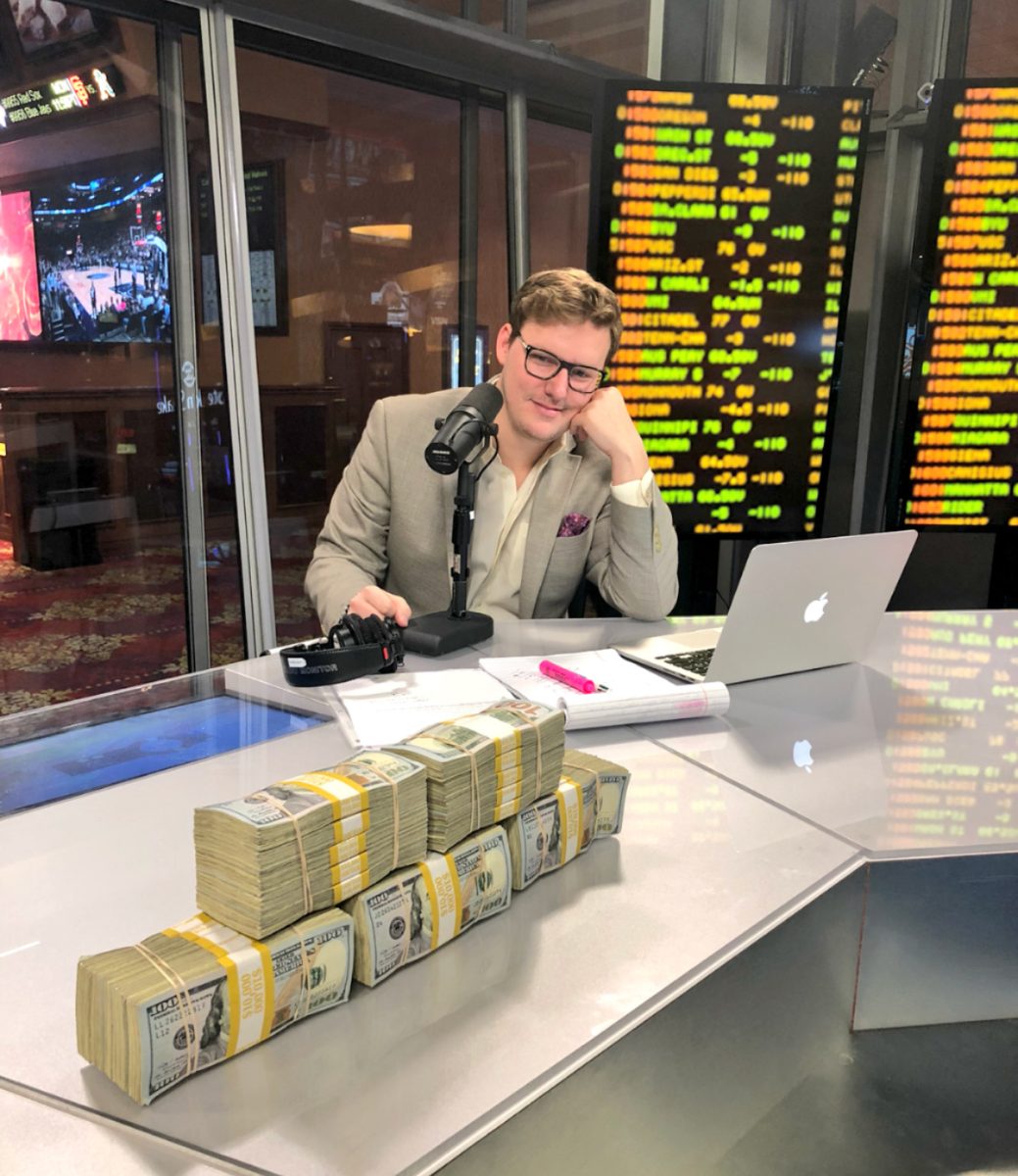 Panayotovich sits at his ViSN desk looking at a stack of money before going live for his show.
