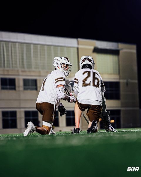 Senior Captain Ryland Supurgeci (left) and Freshman attackman Paddy Hogan rest together during a timeout vs Evanston on March 24th, 2026.

