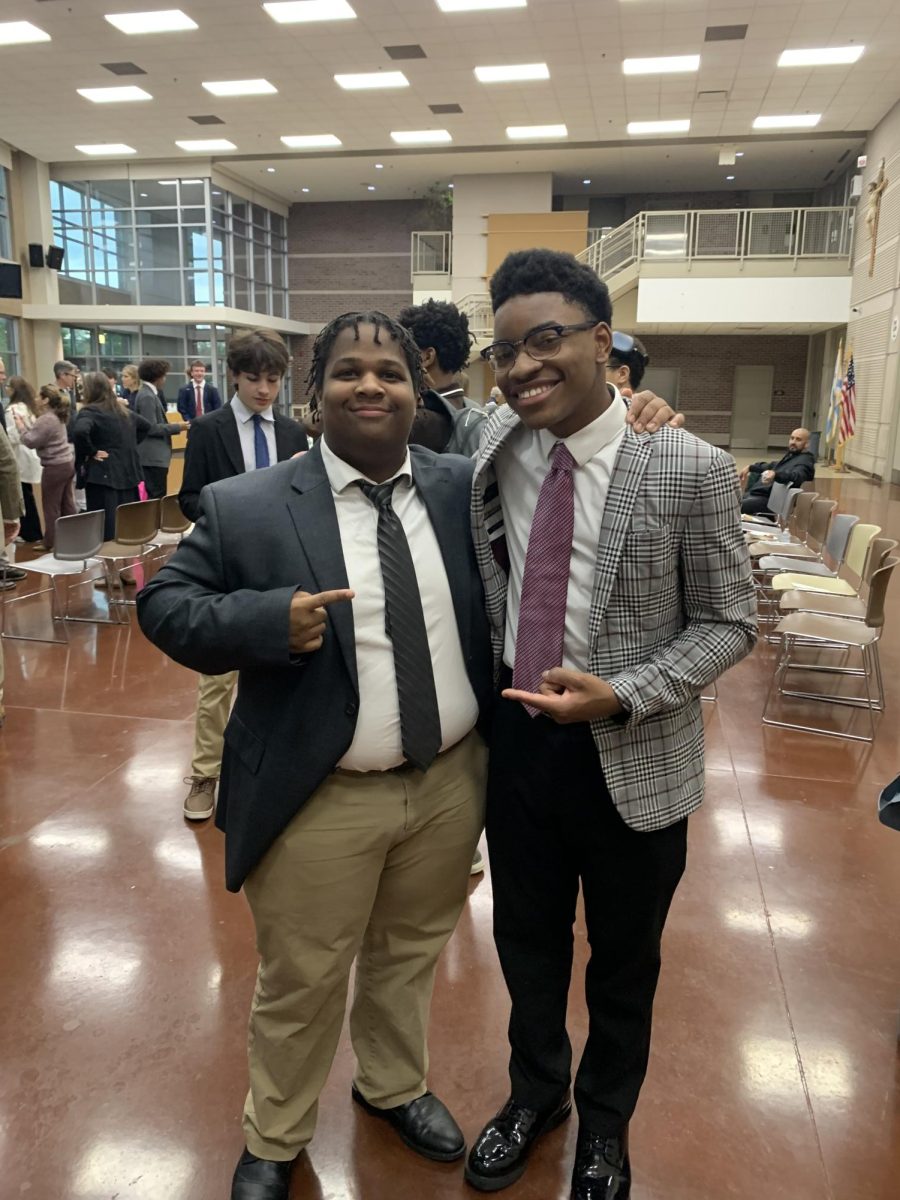 Jeremy Ingram (left) and Aaron Hyler celebrate after being inducted into NHS. 